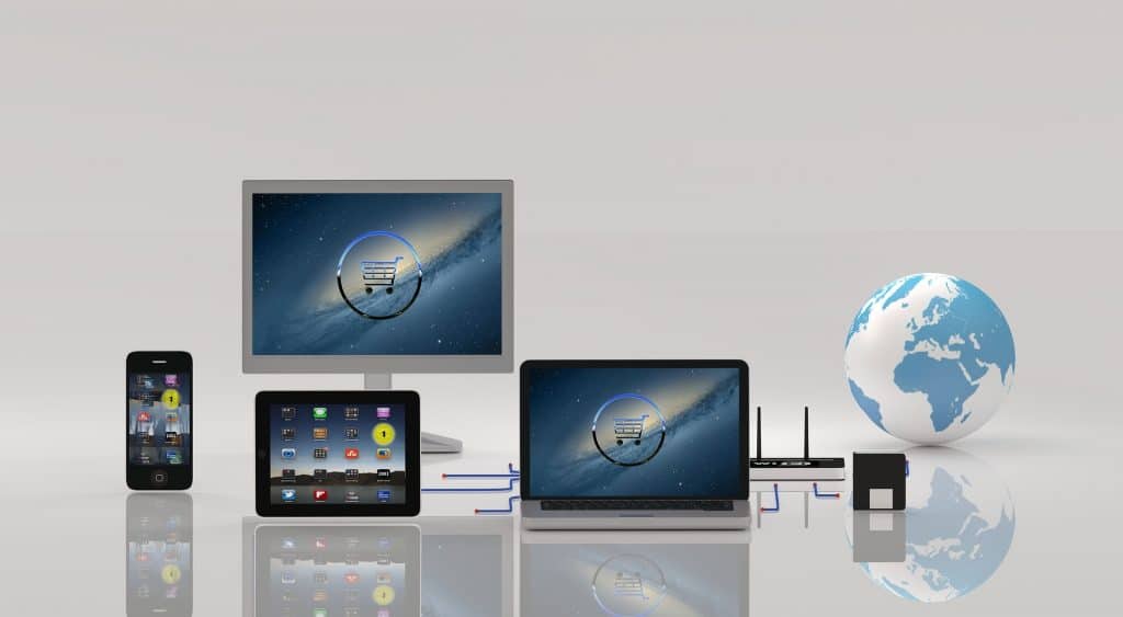 ecommerce website - laptop, tablet and mobile with a world globe on a light gray background